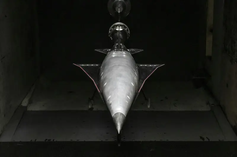 A model aircraft mounted in a wind tunnel test section