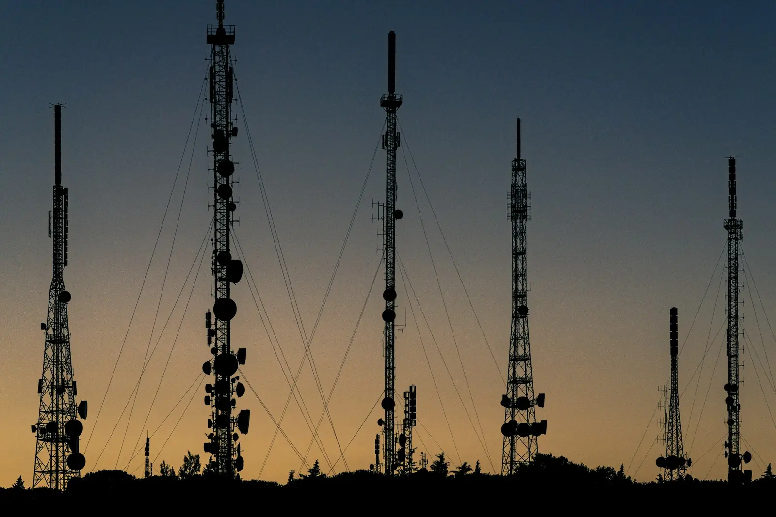 Antenna towers silhouetted at dusk