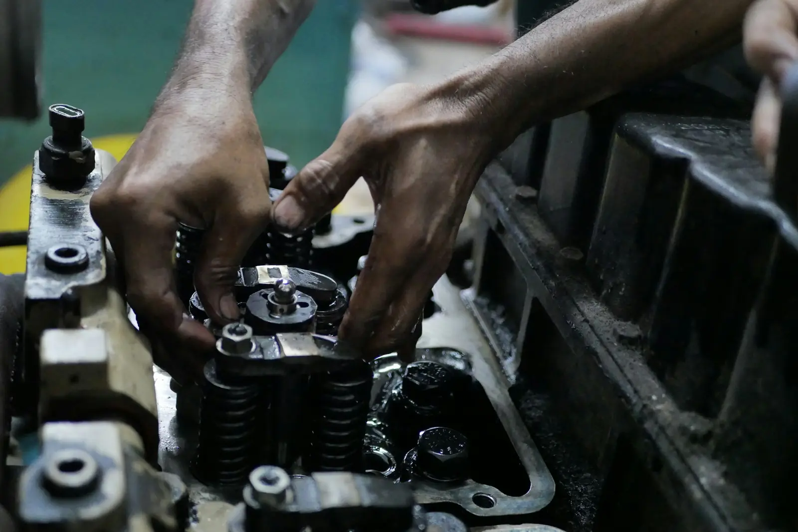 Hands assembling an engine part