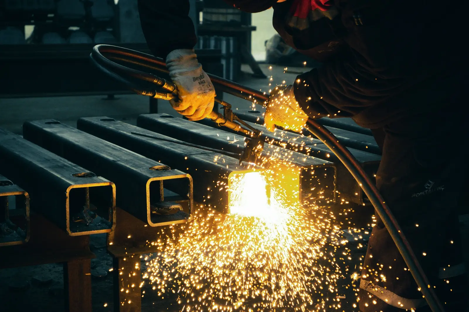 Sparks flying as a worker cuts metal
